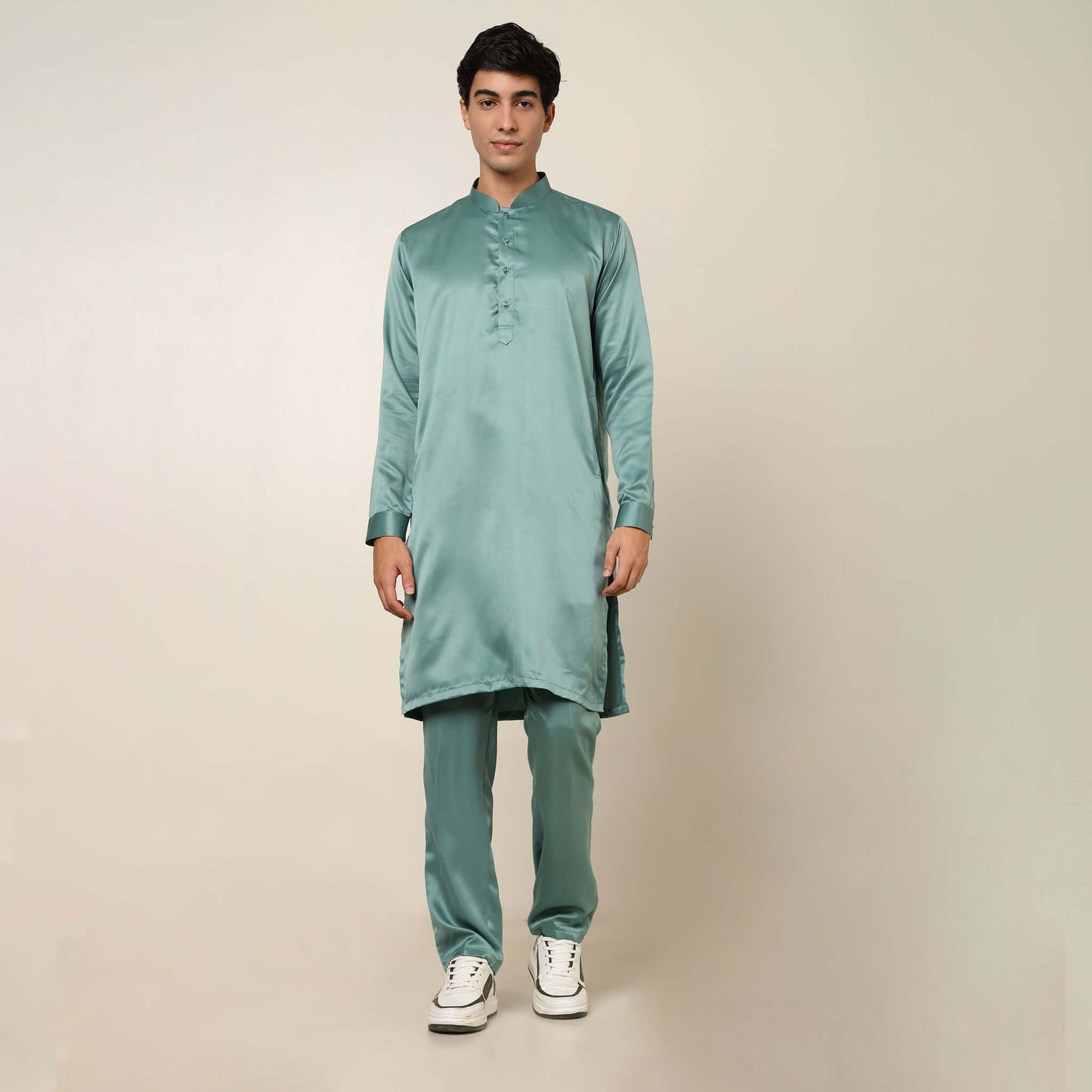 Model posing in light sea green kurta jacket set for men by Crease India, which is made up of satin & has embroidery on jacket. Ideal for groom and guests at Indian wedding reception, engagement, sangeet, anniversary and traditional festivals. Shop this m