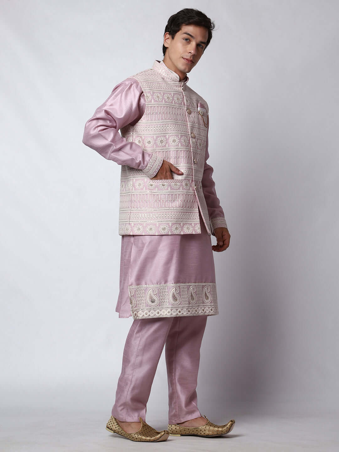  Mauve Kurta Pant with Jacket for men available online in India. A sophisticated men's ethnic wear ensemble featuring a mauve dupion silk kurta jacket set. The net embroidered jacket with sequins adds a touch of elegance, while the kurta and pants provide a comfortable fit. This designer kurta jacket set for men is ideal for weddings, Diwali, Eid, Navratri, & more festivals. Shop this designer kurta set for men on Crease India Website.