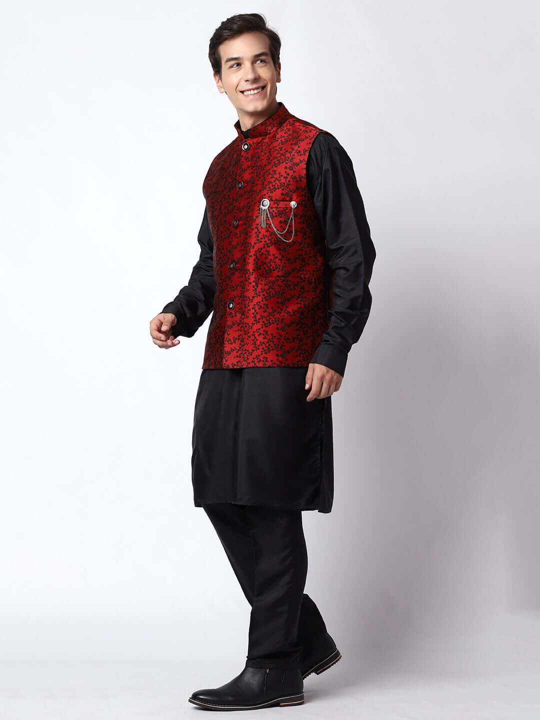 Red & Black kurta jacket set for men available online in India. An elegant men's ethnic wear kurta jacket set with intricate black floral embroidery design on red jacquard jacket. The red jacquard jacket boasts a mandarin collar and complements the black kurta and pants, crafted from smooth cotton silk. This designer red jacquard kurta jacket set for men is ideal for weddings, Diwali, Eid, Navratri, & more festivals. Shop this designer red & black kurta set for men at Crease India Website.