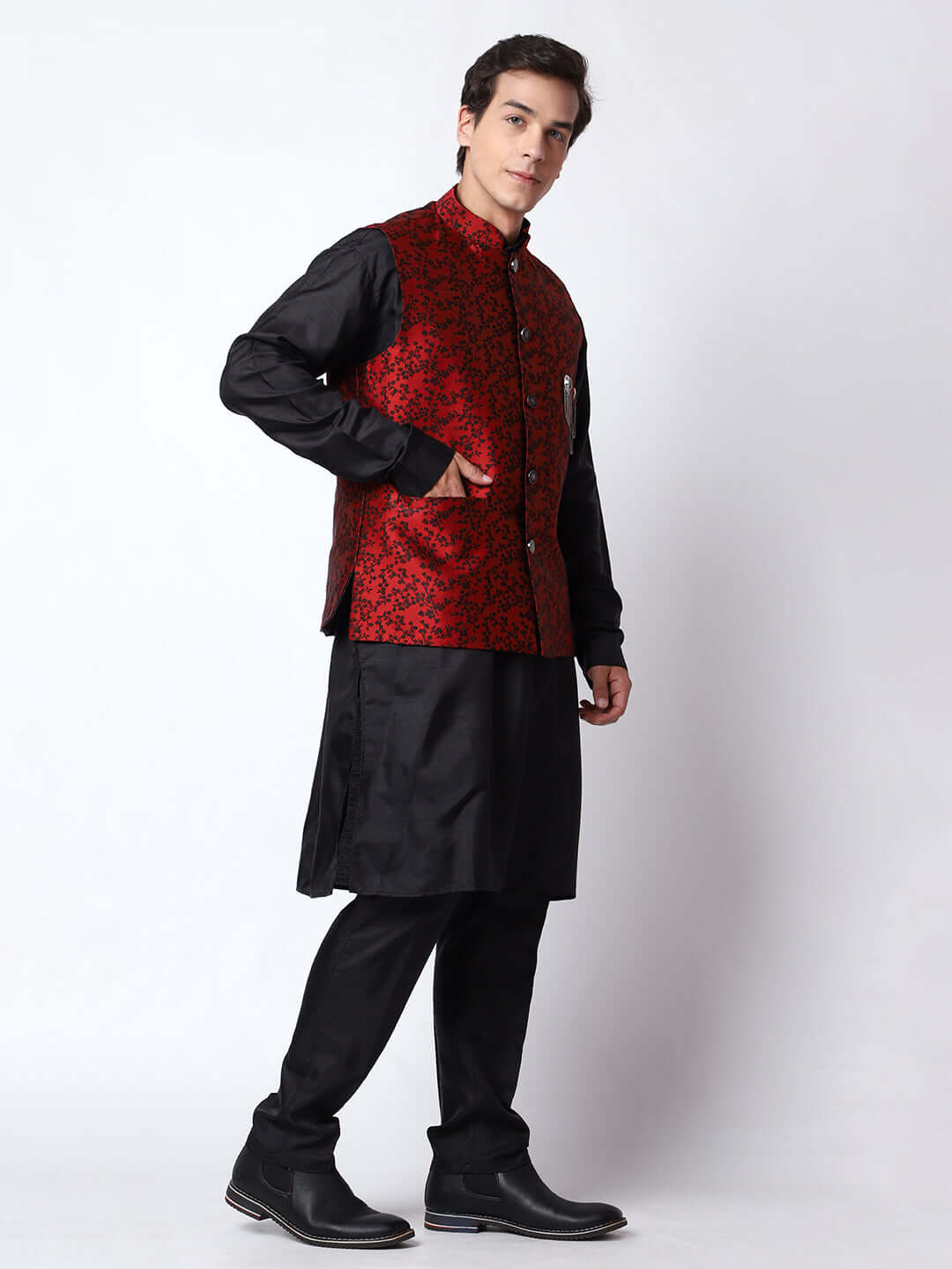 Red & Black kurta jacket set for men available online in India. An elegant men's ethnic wear kurta jacket set with intricate black floral embroidery design on red jacquard jacket. The red jacquard jacket boasts a mandarin collar and complements the black kurta and pants, crafted from smooth cotton silk. This designer red jacquard kurta jacket set for men is ideal for weddings, Diwali, Eid, Navratri, & more festivals. Shop this designer red & black kurta set for men at Crease India Website.