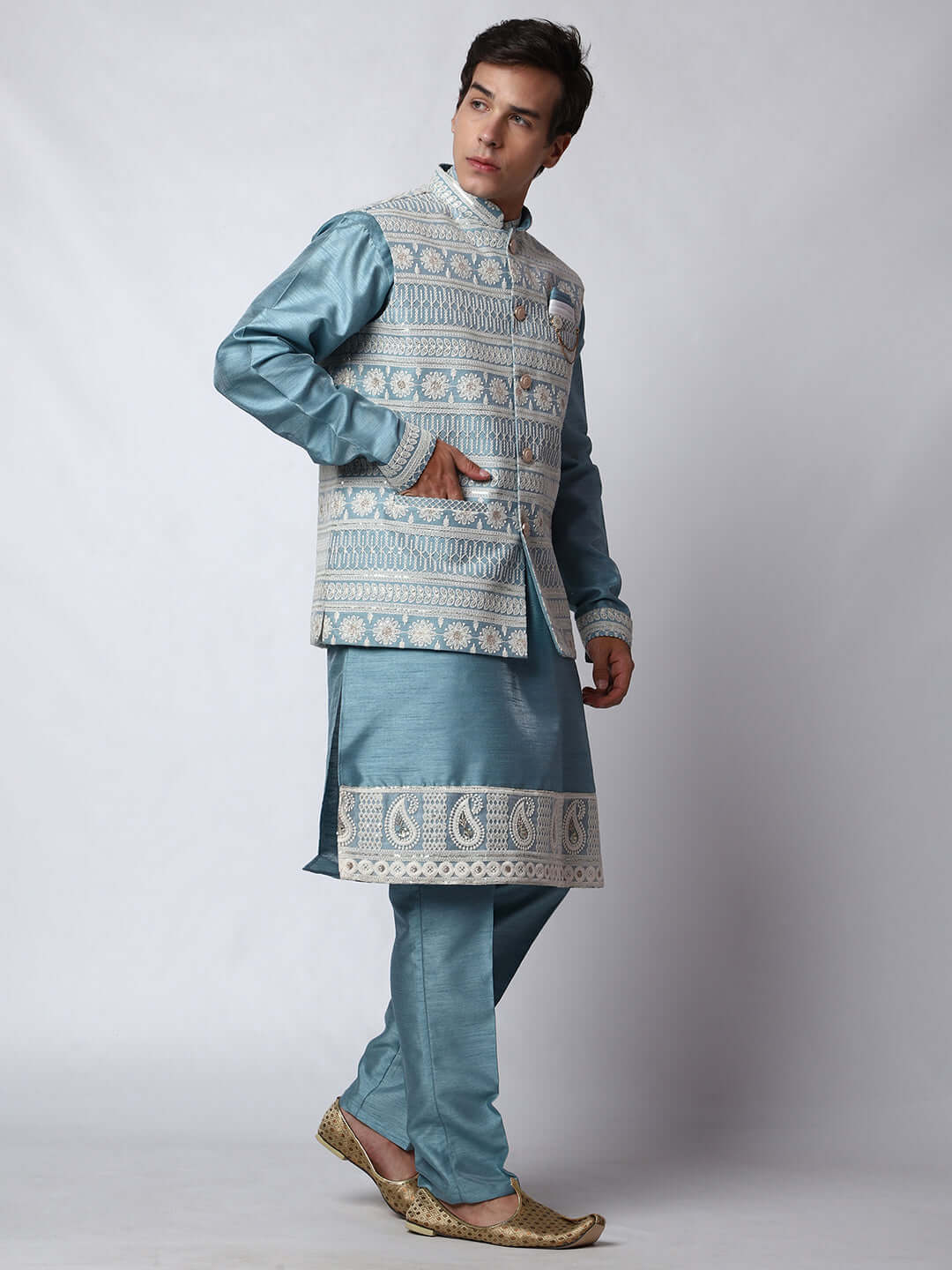 Blue Kurta Pant with Jacket for men available online in India. A sophisticated men's ethnic wear ensemble featuring a blue dupion silk kurta jacket set. The net embroidered jacket with sequins adds a touch of elegance, while the kurta and pants provide a comfortable fit. This designer kurta jacket set for men is ideal for weddings, Diwali, Eid, Navratri, & more festivals. Shop this designer kurta set for men on Crease India Website.