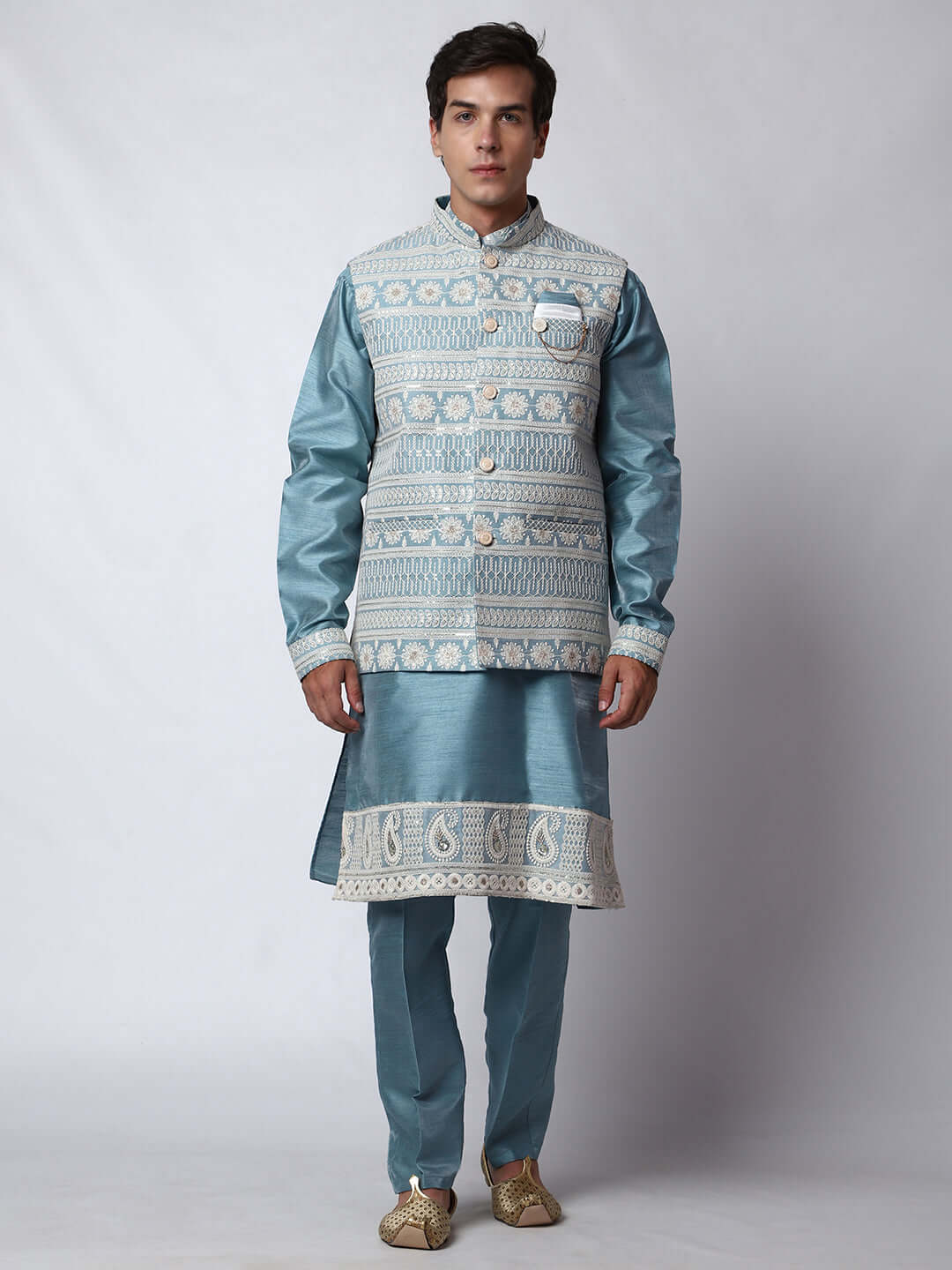 Blue Kurta Pant with Jacket for men available online in India. A sophisticated men's ethnic wear ensemble featuring a blue dupion silk kurta jacket set. The net embroidered jacket with sequins adds a touch of elegance, while the kurta and pants provide a comfortable fit. This designer kurta jacket set for men is ideal for weddings, Diwali, Eid, Navratri, & more festivals. Shop this designer kurta set for men on Crease India Website.