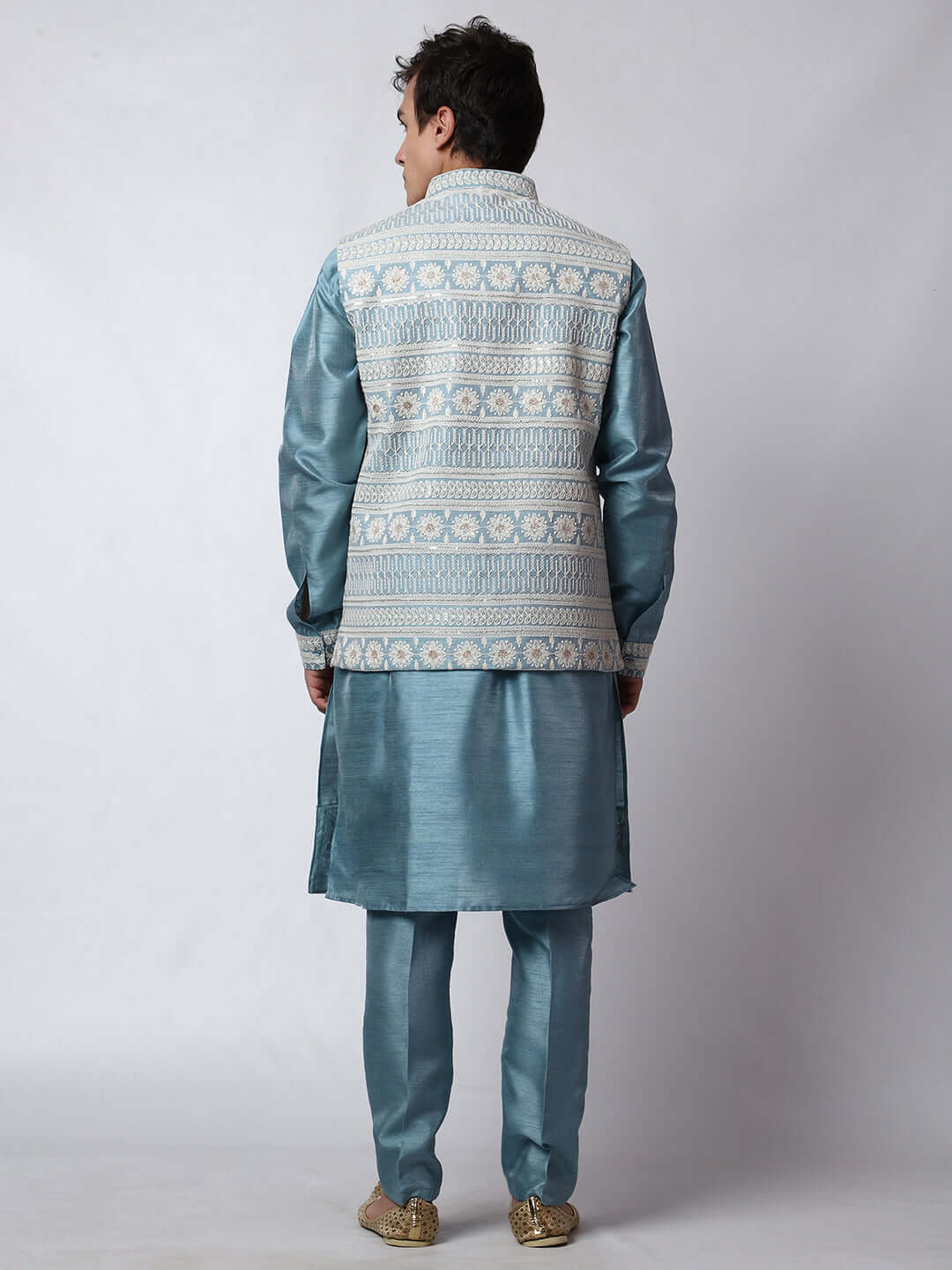 Blue Kurta Pant with Jacket for men available online in India. A sophisticated men's ethnic wear ensemble featuring a blue dupion silk kurta jacket set. The net embroidered jacket with sequins adds a touch of elegance, while the kurta and pants provide a comfortable fit. This designer kurta jacket set for men is ideal for weddings, Diwali, Eid, Navratri, & more festivals. Shop this designer kurta set for men on Crease India Website.