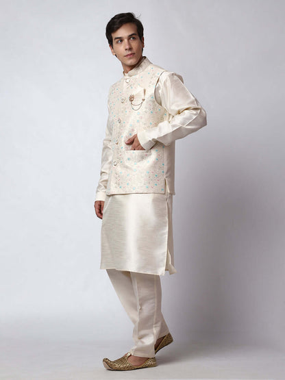 Cream Dupion Silk Kurta Pant Jacket Set for Men. This designer kurta set for men features a luxurious dupion silk jacket adorned with intricate and vibrant multicolored thread embroidery. The matching cream dupion silk kurta and pants complement the embroidered jacket beautifully. This men's kurta set is ideal for weddings, Diwali, Eid, Navratri, & special occasions. Buy this designer kurta jacket set for men at Crease India website.