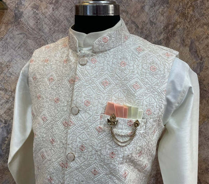 The Cream Kurta jacket set for men is available online in India. The jacket is made with a cream color jacquard silk and have multicolored threadword. It has a mandarin collar and goes with a matching cream hue dupion silk kurta &amp; pants. This cream designer kurta set for men is perfect for weddings, wedding functions, parties, Diwali, Eid, Navratri & other traditional events. Shop this designer kurta jacket set for gents at the Crease India Website.