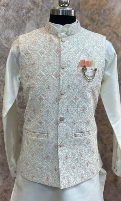 The Cream Kurta jacket set for men is available online in India. The jacket is made with a cream color jacquard silk and have multicolored threadword. It has a mandarin collar and goes with a matching cream hue dupion silk kurta &amp; pants. This cream designer kurta set for men is perfect for weddings, wedding functions, parties, Diwali, Eid, Navratri & other traditional events. Shop this designer kurta jacket set for gents at the Crease India Website.