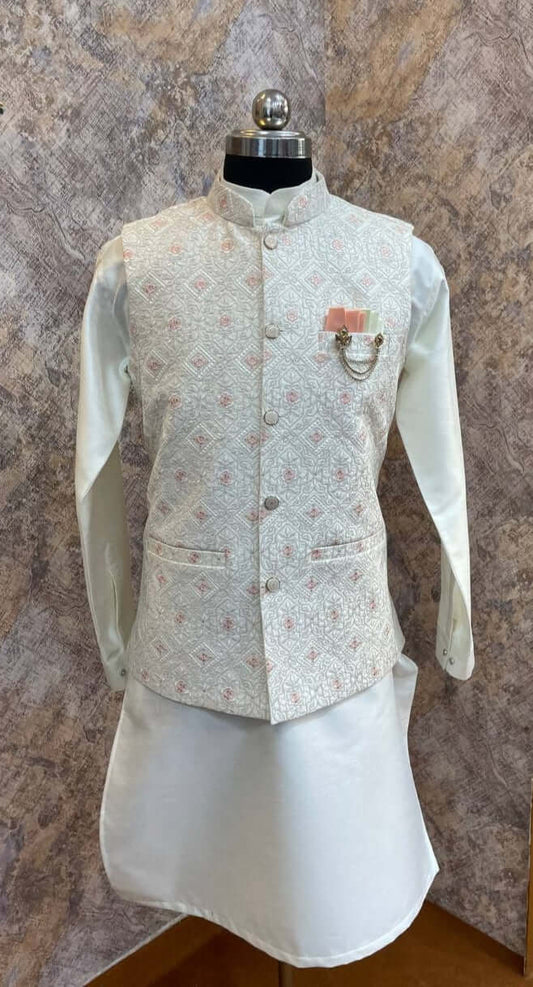 The Cream Kurta jacket set for men is available online in India. The jacket is made with a cream color jacquard silk and have multicolored threadword. It has a mandarin collar and goes with a matching cream hue dupion silk kurta &amp; pants. This cream designer kurta set for men is perfect for weddings, wedding functions, parties, Diwali, Eid, Navratri & other traditional events. Shop this designer kurta jacket set for gents at the Crease India Website.