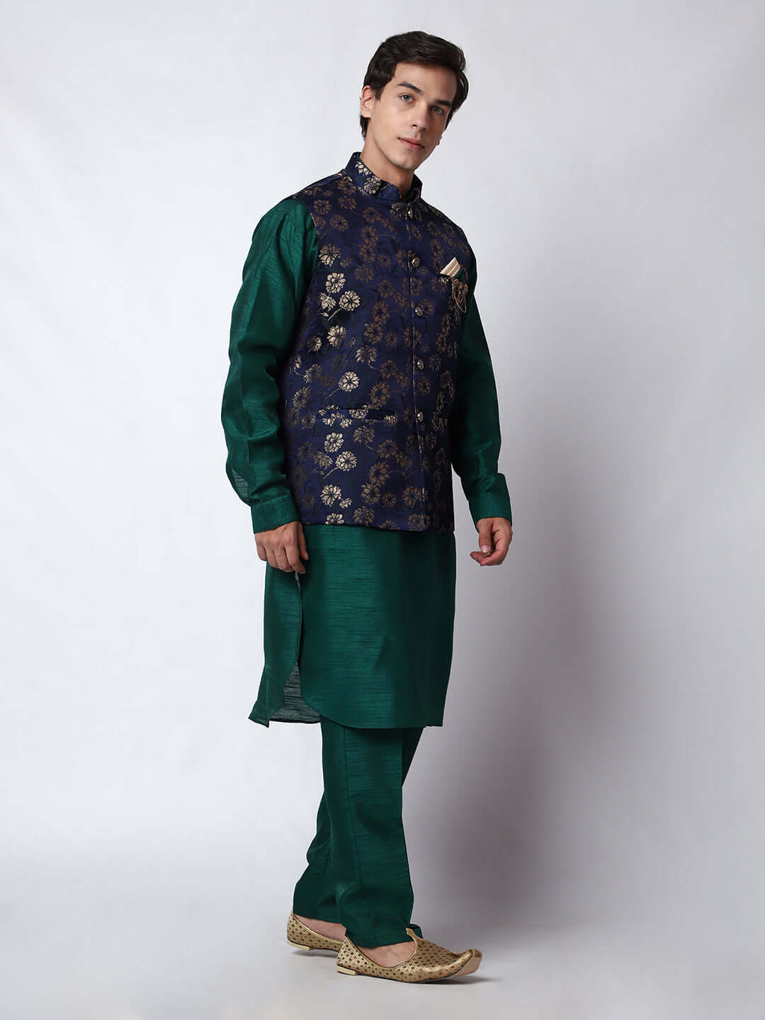 Dark Green kurta jacket set for men available online in India. An elegant men's ethnic wear kurta jacket set with intricate golden floral embroidery. The sophisticated midnight blue jacket boasts a mandarin collar and complements the dark green kurta and pants, crafted from smooth dupion silk. This designer kurta jacket set for men is ideal for weddings, Diwali, Eid, Navratri, & more festivals. Shop this designer kurta set for men on Crease India Website.