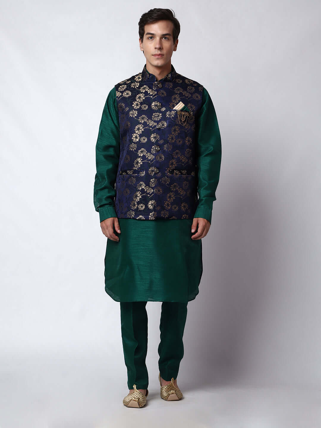 Dark Green kurta jacket set for men available online in India. An elegant men's ethnic wear kurta jacket set with intricate golden floral embroidery. The sophisticated midnight blue jacket boasts a mandarin collar and complements the dark green kurta and pants, crafted from smooth dupion silk. This designer kurta jacket set for men is ideal for weddings, Diwali, Eid, Navratri, & more festivals. Shop this designer kurta set for men on Crease India Website.