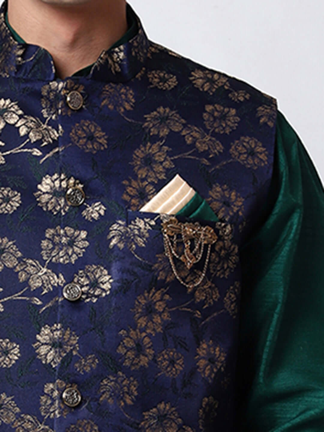 Dark Green kurta jacket set for men available online in India. An elegant men's ethnic wear kurta jacket set with intricate golden floral embroidery. The sophisticated midnight blue jacket boasts a mandarin collar and complements the dark green kurta and pants, crafted from smooth dupion silk. This designer kurta jacket set for men is ideal for weddings, Diwali, Eid, Navratri, & more festivals. Shop this designer kurta set for men on Crease India Website.