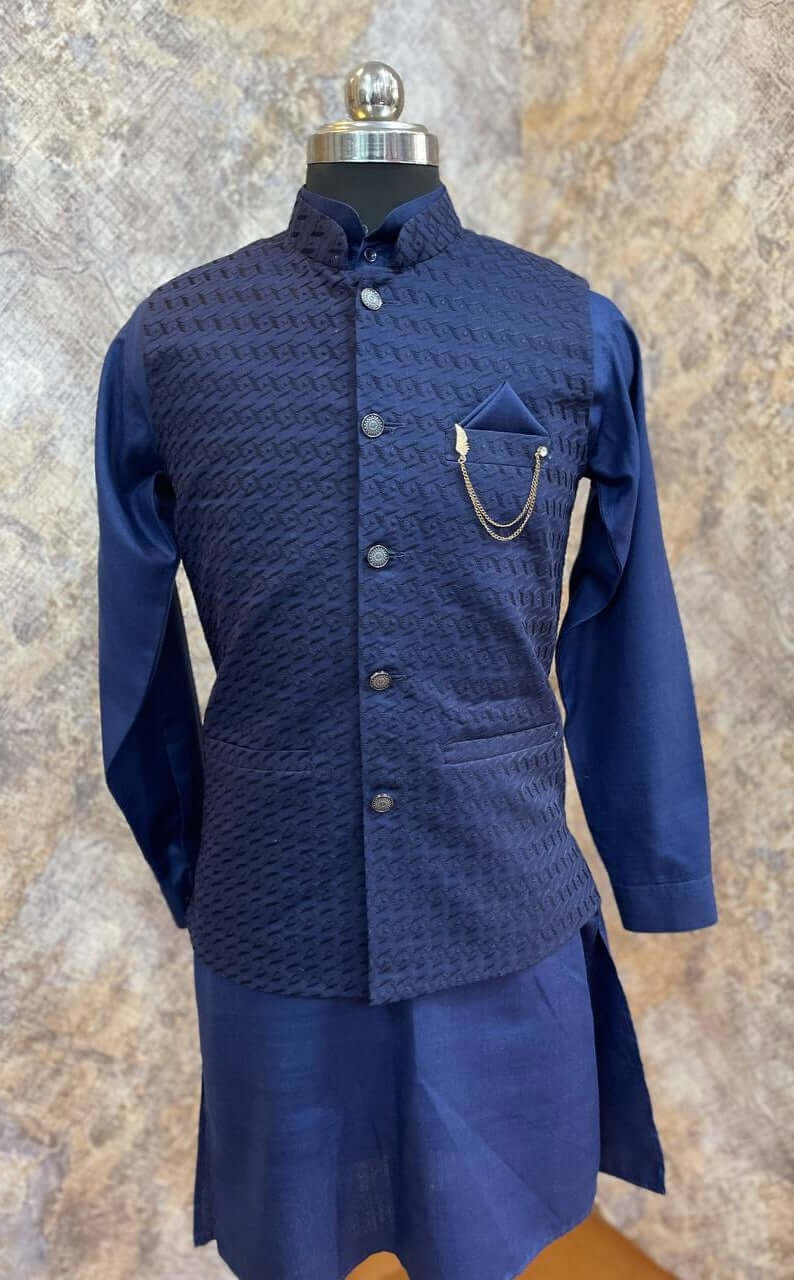 Deep Blue Kurta jacket set for men is  available online in India. The jacket is made up of deep blue voile cotton with chikankari work. It has a mandarin collar and goes with matching blue hue pure cotton kurta & pants. This designer kurta set for men is perfect for weddings, parties, Diwali, Eid, Navratri & other traditional events. Shop this designer kurta jacket set for gents at the Crease India Website.