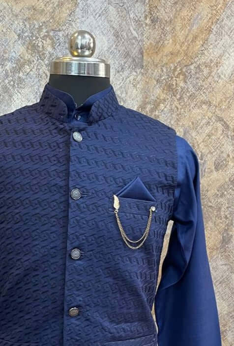 Deep Blue Kurta jacket set for men is  available online in India. The jacket is made up of deep blue voile cotton with chikankari work. It has a mandarin collar and goes with matching blue hue pure cotton kurta & pants. This designer kurta set for men is perfect for weddings, parties, Diwali, Eid, Navratri & other traditional events. Shop this designer kurta jacket set for gents at the Crease India Website.