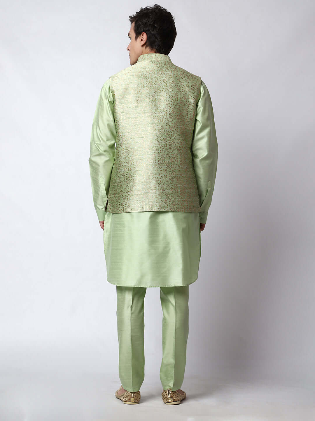 Lush Green kurta jacket set for men available online in India. An elegant men's ethnic wear kurta jacket set with intricate golden petal embroidery. The embroidered jacket boasts a mandarin collar and complements the same hue kurta and pants, crafted from smooth dupion silk. This lush green designer kurta jacket set for men is ideal for weddings, Diwali, Eid, Navratri, & more festivals. Shop this lush green designer kurta set for men on Crease India Website.