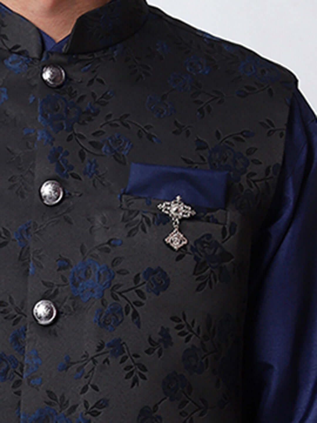 Navy Blue kurta jacket set for men available online in India. An elegant men's ethnic wear kurta jacket set with intricate floral work on black jacquard silk jacket. The black jacket boasts a mandarin collar and complements the navy blue kurta and pants, crafted from smooth cotton silk. This navy blue designer kurta jacket set for men is ideal for weddings, Diwali, Eid, Navratri, & other traditional events. Shop this navy blue designer kurta set for men on Crease India Website.