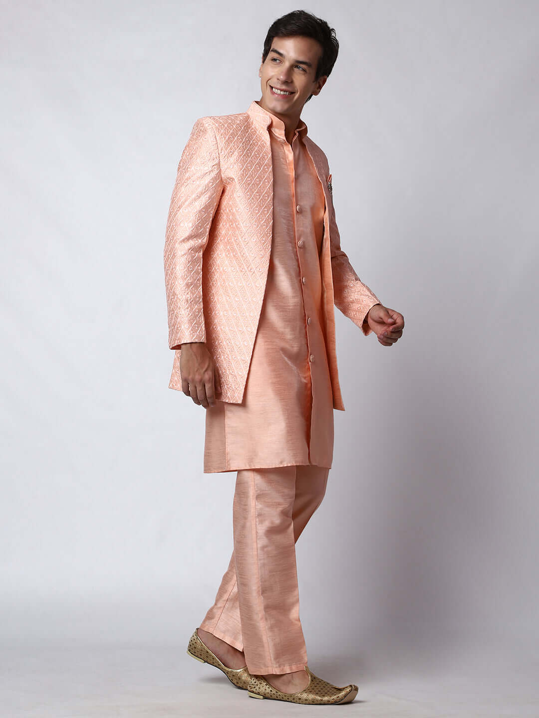 Peach Indo Western Dress for men which is made up of dupion silk with heavy embroidery, perfect for Indian weddings. Shop this mens indo western dress from Crease India website.