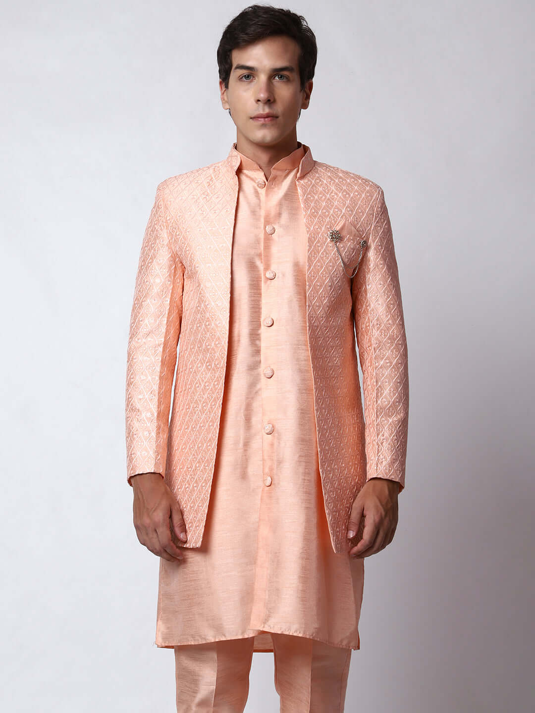 Peach Indo Western Dress for men which is made up of dupion silk with heavy embroidery, perfect for Indian weddings. Shop this mens indo western dress from Crease India website.