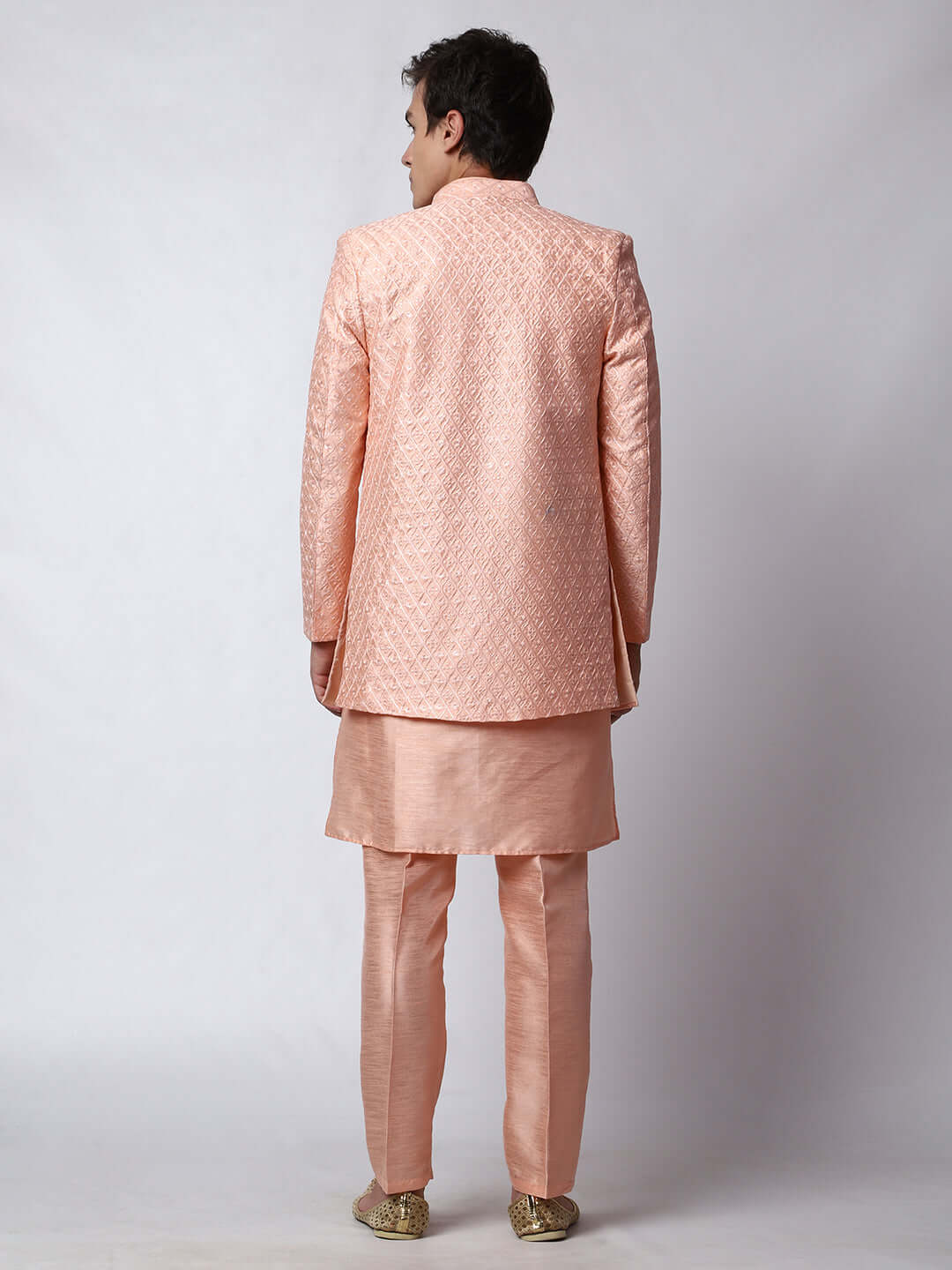 Peach Indo Western Dress for men which is made up of dupion silk with heavy embroidery, perfect for Indian weddings. Shop this mens indo western dress from Crease India website.