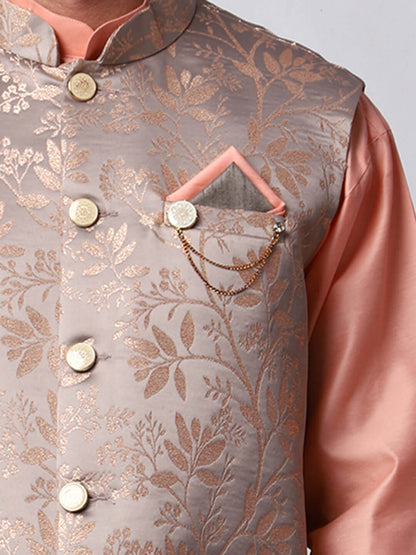 Peach kurta jacket set for men available online in India. An elegant men's ethnic wear kurta jacket set with intricate peach floral embroidery design on grey satin jacquard jacket. The grey satin jacquard jacket boasts a mandarin collar and complements the peach kurta and pants, crafted from smooth cotton silk. This designer peach satin jacquard kurta jacket set for men is ideal for weddings, Diwali, Eid, Navratri, & more festivals. Shop this designer peach kurta set for men at Crease India Website