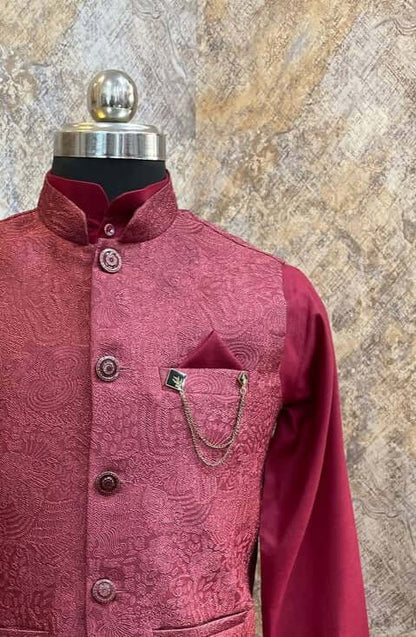 The Garnet Pink Kurta jacket set for men is available online in India. The jacket is made with an imported jacquard with embossed patterns. It has a mandarin collar and goes with a pink hue ruby silk kurta & pants. This garnet pink designer kurta set for men is perfect for weddings, parties, Diwali, Eid, Navratri & other traditional events. Shop this pink designer kurta jacket set for gents at the Crease India Website.