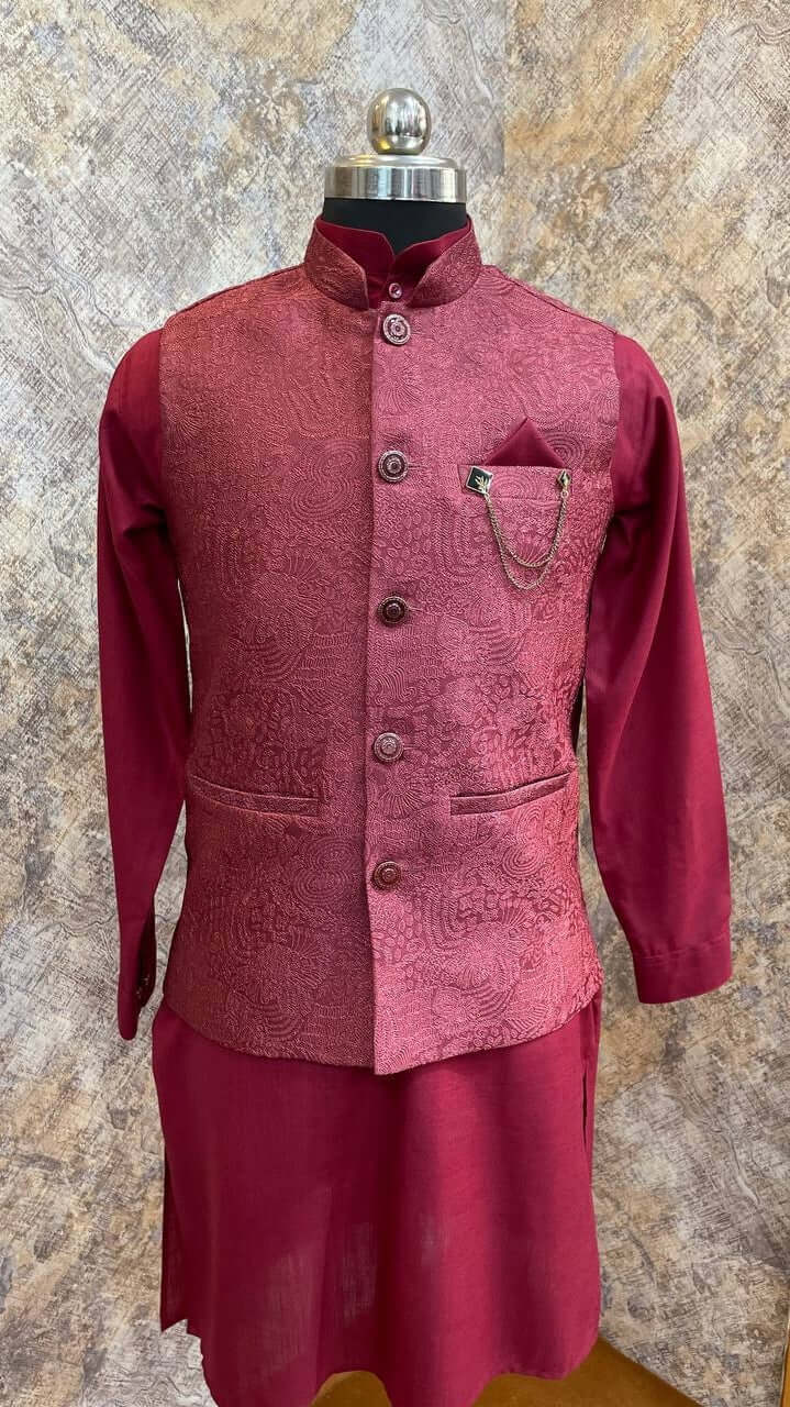 The Garnet Pink Kurta jacket set for men is available online in India. The jacket is made with an imported jacquard with embossed patterns. It has a mandarin collar and goes with a pink hue ruby silk kurta & pants. This garnet pink designer kurta set for men is perfect for weddings, parties, Diwali, Eid, Navratri & other traditional events. Shop this pink designer kurta jacket set for gents at the Crease India Website.