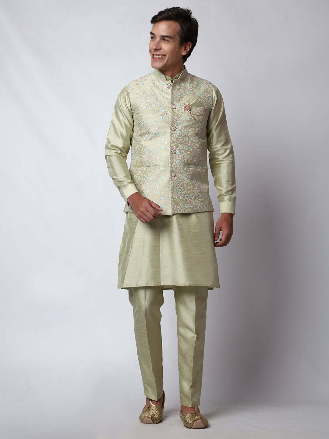 Pista Green Dupion Silk Kurta Pant Jacket Set for Men. This designer kurta set for men features a luxurious dupion silk jacket adorned with intricate and vibrant multicolored thread embroidery. The matching pista green dupion silk kurta and pants complement the embroidered jacket beautifully. This men's kurta set is ideal for weddings, Diwali, Eid, Navratri, & special occasions. Buy this designer kurta jacket set for men at Crease India website.