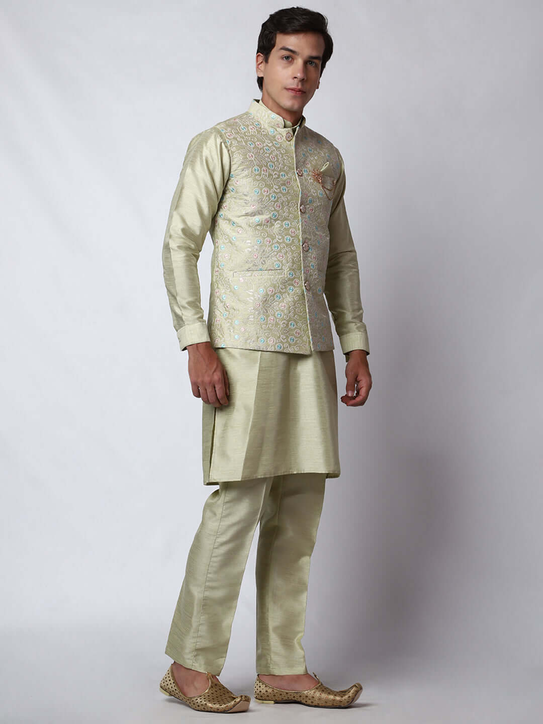 Pista Green Dupion Silk Kurta Pant Jacket Set for Men. This designer kurta set for men features a luxurious dupion silk jacket adorned with intricate and vibrant multicolored thread embroidery. The matching pista green dupion silk kurta and pants complement the embroidered jacket beautifully. This men's kurta set is ideal for weddings, Diwali, Eid, Navratri, & special occasions. Buy this designer kurta jacket set for men at Crease India website.