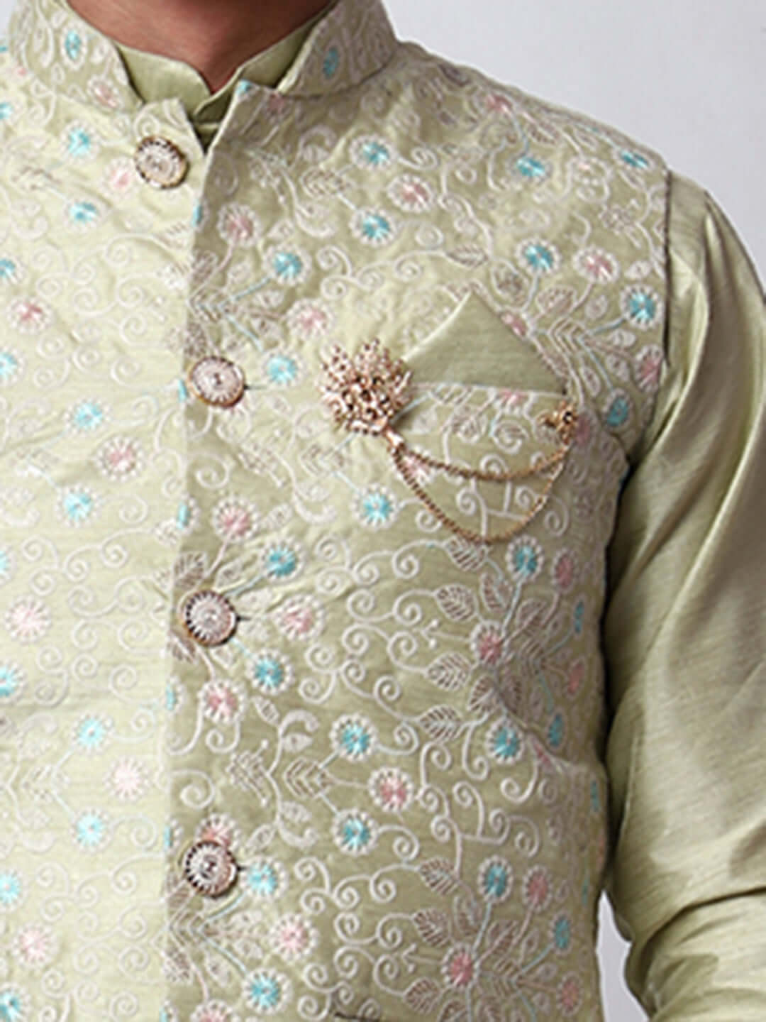 Pista Green Dupion Silk Kurta Pant Jacket Set for Men. This designer kurta set for men features a luxurious dupion silk jacket adorned with intricate and vibrant multicolored thread embroidery. The matching pista green dupion silk kurta and pants complement the embroidered jacket beautifully. This men's kurta set is ideal for weddings, Diwali, Eid, Navratri, & special occasions. Buy this designer kurta jacket set for men at Crease India website.