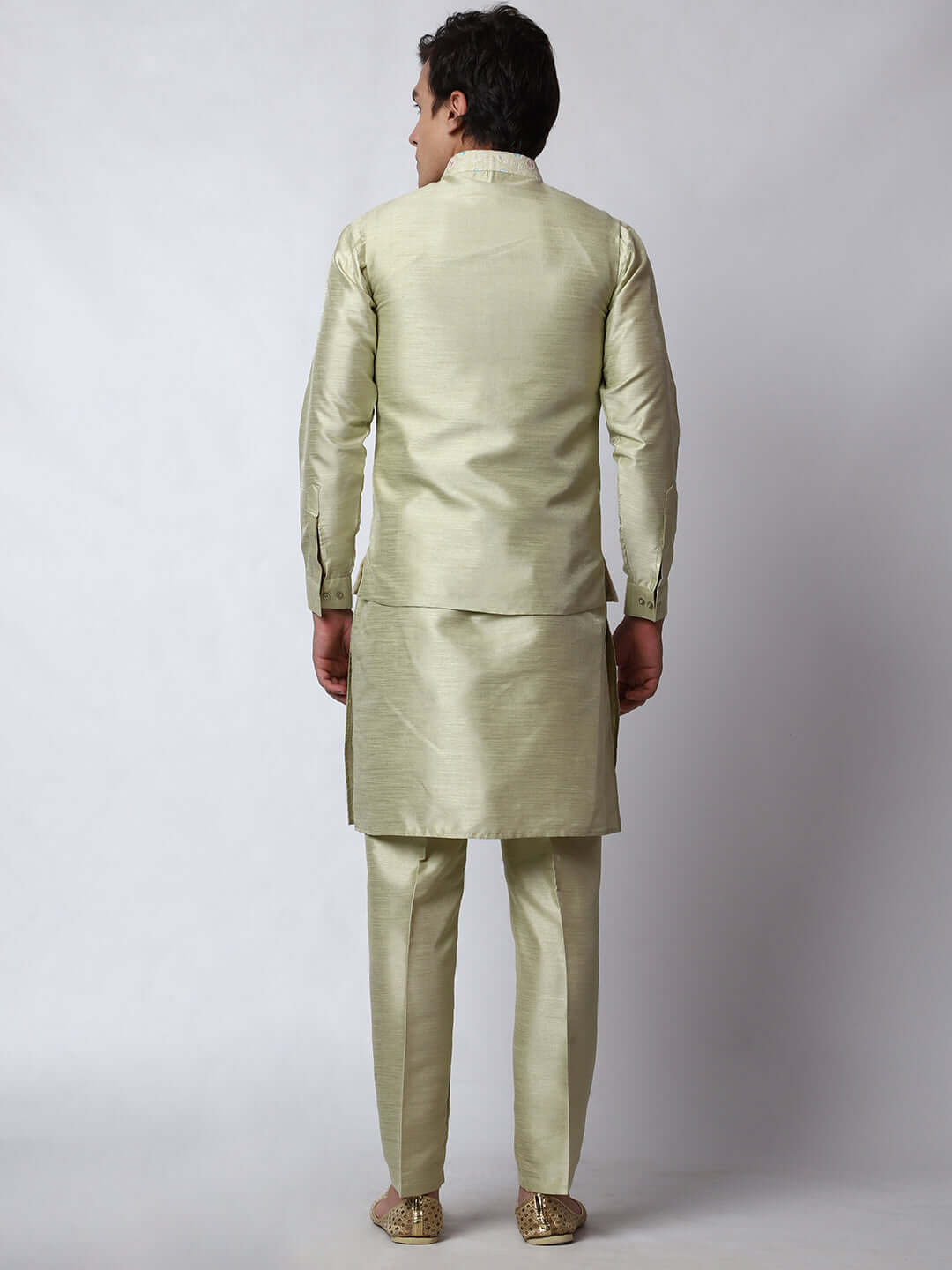 Pista Green Dupion Silk Kurta Pant Jacket Set for Men. This designer kurta set for men features a luxurious dupion silk jacket adorned with intricate and vibrant multicolored thread embroidery. The matching pista green dupion silk kurta and pants complement the embroidered jacket beautifully. This men's kurta set is ideal for weddings, Diwali, Eid, Navratri, & special occasions. Buy this designer kurta jacket set for men at Crease India website.