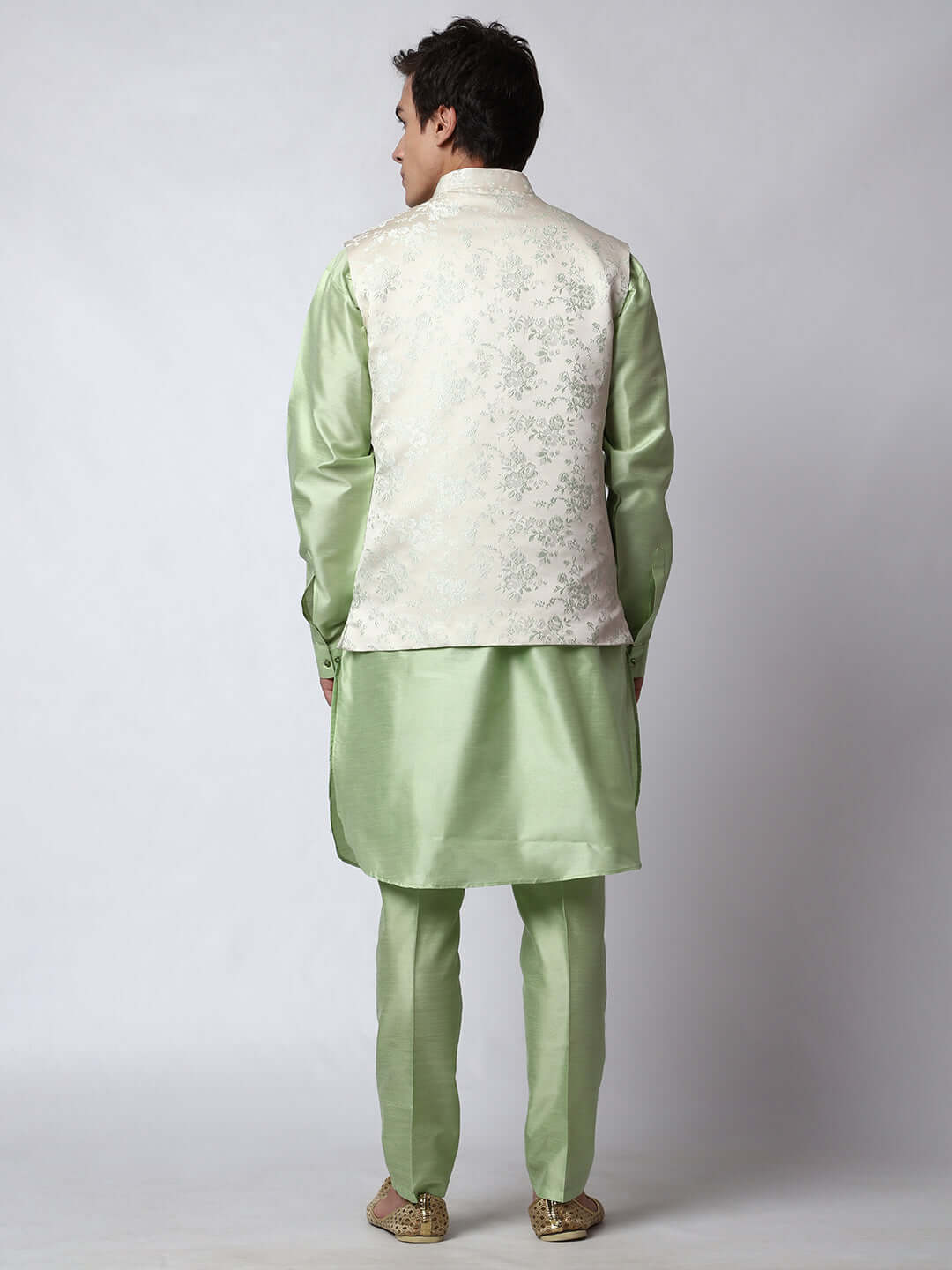 Pista Green kurta jacket set for men available online in India. An elegant men's ethnic wear kurta jacket set with intricate floral embroidery on white jacquard jacket. The white jacquard jacket boasts a mandarin collar and complements the pista green kurta and pants, crafted from smooth dupion silk. This pista green designer kurta jacket set for men is ideal for weddings, Diwali, Eid, Navratri, & more festivals. Shop this pista green designer kurta set for men on Crease India Website.