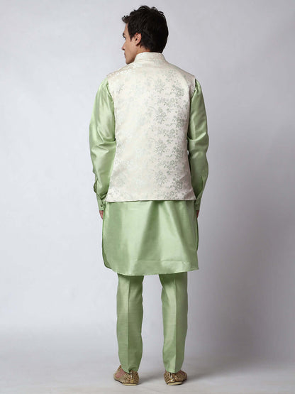 Pista Green kurta jacket set for men available online in India. An elegant men's ethnic wear kurta jacket set with intricate floral embroidery on white jacquard jacket. The white jacquard jacket boasts a mandarin collar and complements the pista green kurta and pants, crafted from smooth dupion silk. This pista green designer kurta jacket set for men is ideal for weddings, Diwali, Eid, Navratri, & more festivals. Shop this pista green designer kurta set for men on Crease India Website.